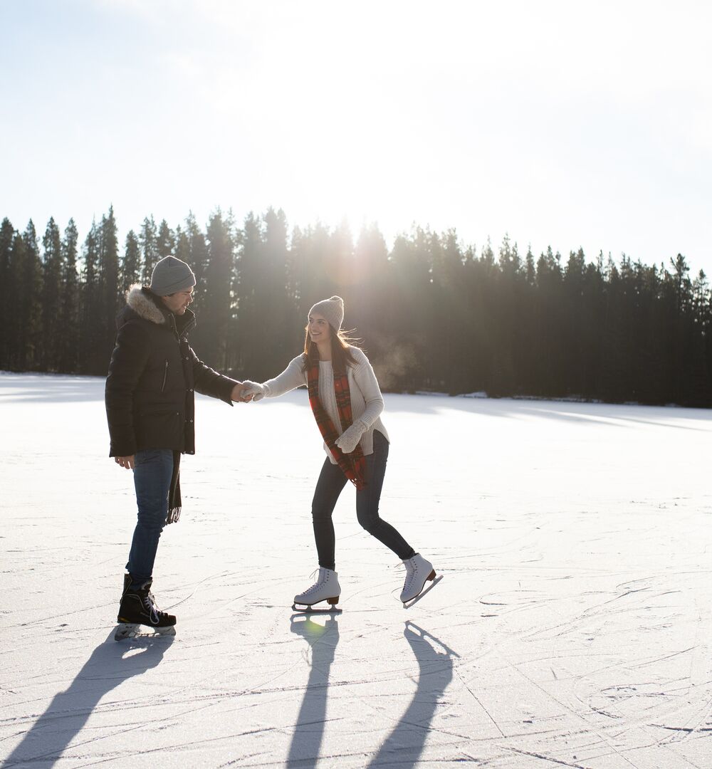 Couple skating on a frozen lake
